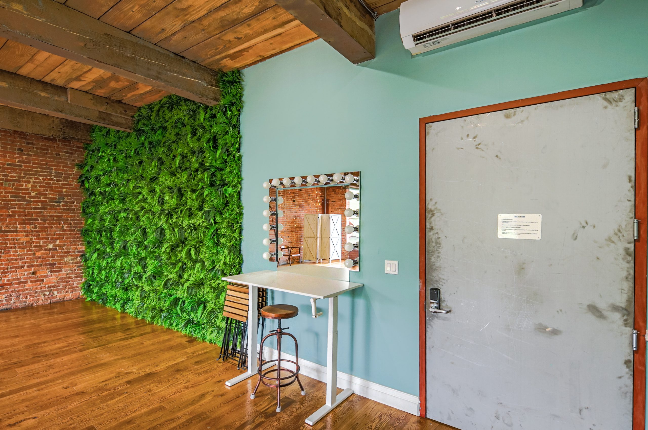 photo studio's vanity area with fern filled wall