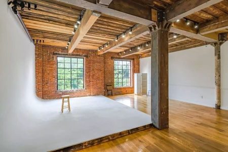 inside of a photo and film rental studio with wood style design and white background